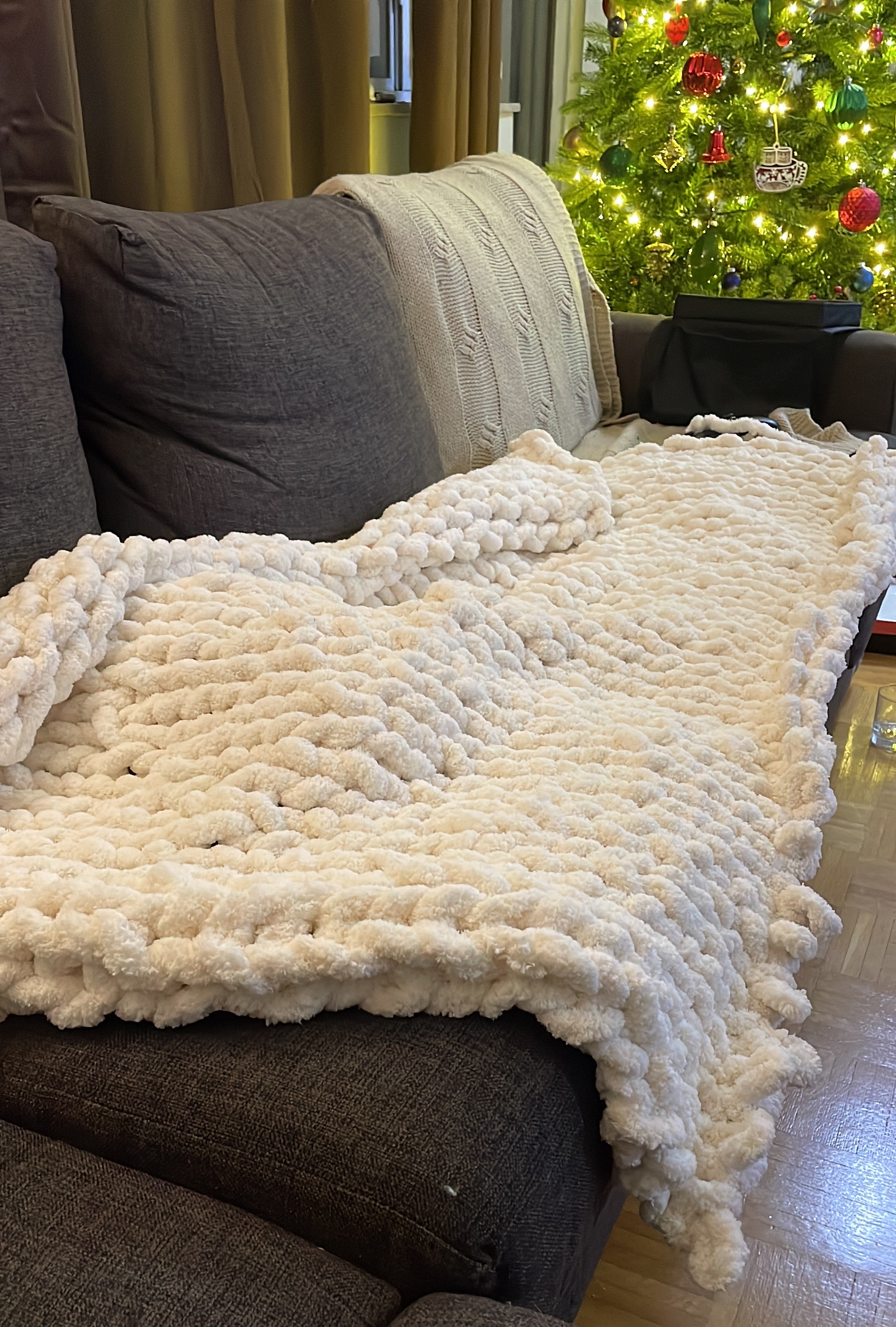 white thick yarn blanket on couch